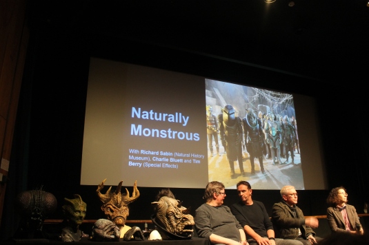 From left: Doctor Who monster prosthetic heads of Tritovore, Silurian, the Minotor and Judoon lay on a table next to Tim Berry and Charlie Bluett from the Doctor Who Special Effects team, Richard Sabin, scientist at the Natural History Museum.